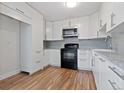 Eat-in kitchen features white cabinets, granite countertops, and stainless steel appliances at 11912 Madison Pl, Thornton, CO 80223