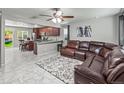 Open-concept living space showcasing kitchen, living area, and bright, natural light at 18672 E Chaffee Pl, Denver, CO 80249