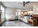 Open-concept living area showcasing a large sectional couch adjacent to the gourmet kitchen at 15160 W Iliff Pl, Lakewood, CO 80228