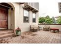 Inviting patio with brick pavers, comfortable seating and beautiful flower pot at 15160 W Iliff Pl, Lakewood, CO 80228