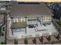 Spacious backyard featuring a large patio, pergola, and well-manicured landscaping at 5128 Preserve Pl, Firestone, CO 80504