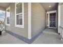 Inviting front porch featuring ample lighting and a decorative front door at 5128 Preserve Pl, Firestone, CO 80504