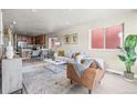 Bright, modern living room and dining area with wood floors and an open layout at 5760 N Boston St, Denver, CO 80238
