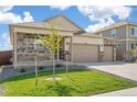 Beautiful home with a well-maintained lawn, stone accents, and a covered front porch at 4723 Windmill Dr, Brighton, CO 80601