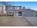 Charming two-story home featuring an attached two-car garage and well-maintained front yard at 7745 S Trenton Ct, Centennial, CO 80112
