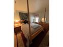 Bedroom with a four-poster bed, wooden dresser, and bright natural light at 1901 Clear Creek Dr # A-104, Georgetown, CO 80444