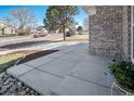 Inviting front yard view showcasing a well-maintained walkway and landscaping at 5821 S Quatar Cir, Centennial, CO 80015