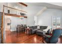 Bright living room with high ceilings, hardwood floors, and a cozy seating area at 5821 S Quatar Cir, Centennial, CO 80015