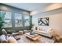 Comfortable living room with large windows, neutral sofa, stylish rug, and modern decor at 1919 W 46Th Ave # 3, Denver, CO 80211