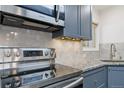 Stainless steel Samsung range and microwave in updated kitchen at 1440 S Logan St, Denver, CO 80210