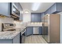 Modern kitchen featuring stainless steel appliances and granite countertops at 1440 S Logan St, Denver, CO 80210