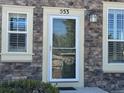 Close-up of the front entrance with stone facade and complementary trim at 553 Hanging Rock Pl, Castle Rock, CO 80108