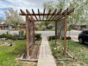 Inviting walkway with a wooden pergola and lattice side panels, leading to the home at 1965 Havana St, Aurora, CO 80010