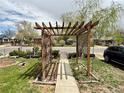 Inviting front yard with a charming pergola-covered walkway at 1965 Havana St, Aurora, CO 80010