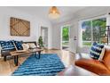 Bright living room with hardwood floors, large windows, and stylish modern furnishings at 211 E Emma St, Lafayette, CO 80026