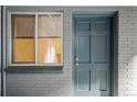 Charming building exterior with a gray brick facade and a muted blue door at 336 N Grant St # 302, Denver, CO 80203