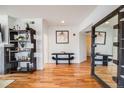 Modern hallway with sleek décor, hardwood floors, and a decorative mirror at 111 S Monroe St # B203, Denver, CO 80209