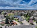 Expansive aerial view of home in quiet neighborhood, mature trees, lush landscaping and mountain views at 3997 S Dawson St, Aurora, CO 80014