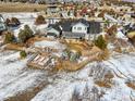 Aerial view of a property featuring a spacious backyard, garden, patio and snow covered ground at 7186 Weaver Cir, Castle Rock, CO 80104