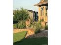 Beautifully landscaped front yard with mature trees, rock features and a deer near the house at 7186 Weaver Cir, Castle Rock, CO 80104