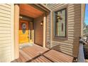 Inviting front entryway with wood porch, a paneled door, and decorative wreath for a warm welcome at 1294 Red Lodge Dr, Evergreen, CO 80439