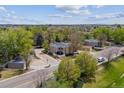 A neighborhood shot of the home shows green trees and other houses in the area at 1160 S Clinton St # 40, Denver, CO 80247