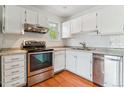 Bright kitchen showcasing stainless steel appliances, granite countertops, and sleek subway tile backsplash at 1160 S Clinton St # 40, Denver, CO 80247