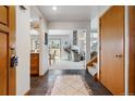 Inviting foyer with tile flooring, wood accents, and an open view to the living spaces at 8822 Fiesta Ter, Lone Tree, CO 80124