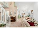 Cozy living room with staircase, comfortable sofa, and bright natural light at 6819 S Webster St # E, Littleton, CO 80128