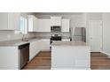 Modern kitchen with white cabinets, stainless steel appliances, and granite countertops at 7303 Dolores Ave, Frederick, CO 80530