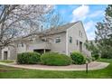 Charming exterior view of a gray two-story condo with well-maintained landscaping at 3600 S Pierce St # 1-207, Denver, CO 80235