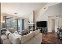 Comfortable living room with sliding door to the exterior and a cozy stone fireplace at 3600 S Pierce St # 1-207, Denver, CO 80235