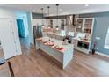 Open kitchen with large island, stainless appliances, designer lighting, and sleek cabinetry at 8 S Colorado Blvd, Denver, CO 80246