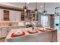 Modern kitchen features a large island, quartz countertops, and designer pendant lighting at 8 S Colorado Blvd, Denver, CO 80246