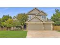 Charming two-story home with a three car garage and well-maintained lawn at 5206 S Meadow Lark Dr, Castle Rock, CO 80109