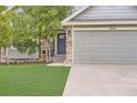 Inviting front entrance with landscaped garden and stone detailing around garage at 5206 S Meadow Lark Dr, Castle Rock, CO 80109