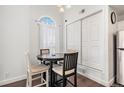 Charming dining area with a round table, seating for four, and a window with natural light at 8391 S Upham Way # 209, Littleton, CO 80128