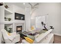 Cozy living room with fireplace, large TV, comfortable seating, and a bright window with a workout bike at 8391 S Upham Way # 209, Littleton, CO 80128