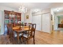 Well-lit dining room with hardwood floors and a decorative chandelier at 635 S Alton Way # 3B, Denver, CO 80247