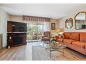 Cozy living room area features a fireplace, comfortable seating, and sliding glass doors to a balcony at 635 S Alton Way # 3B, Denver, CO 80247