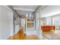 Bright foyer with hardwood floors, detailed trim, and staircase to the second floor at 2062 Eudora St, Denver, CO 80207