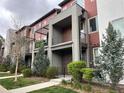 Charming modern townhome featuring private balconies, brick accents, and landscaped front yard at 4280 E Warren Ave # 2, Denver, CO 80222