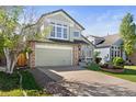 Charming two-story home with a well-manicured lawn, stone accents, and a two-car garage at 5432 S Cathay Way, Centennial, CO 80015