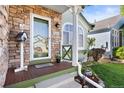 Inviting front porch with stone accents, a wooden deck, and a decorative birdhouse at 5432 S Cathay Way, Centennial, CO 80015