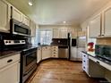 Modern kitchen equipped with stainless steel appliances, granite countertops, and ample cabinet space at 5432 S Cathay Way, Centennial, CO 80015