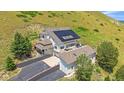 Beautiful home with a rooftop deck and solar panels, perfectly integrated into the natural landscape at 17313 W 43Rd Dr, Golden, CO 80403