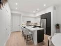Bright kitchen featuring a center island with bar seating, stainless appliances and lots of light at 1815 N Williams St, Denver, CO 80218
