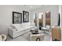 Beautifully decorated living room with modern furniture, stylish art, and ample natural light at 1815 N Williams St, Denver, CO 80218