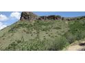 View of a large lot with a rocky hillside at 19689 W 57Th Pl, Golden, CO 80403