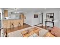 Open floor plan showcasing a living room and part of a kitchen with wooden cabinets at 4501 Bryant St, Denver, CO 80211